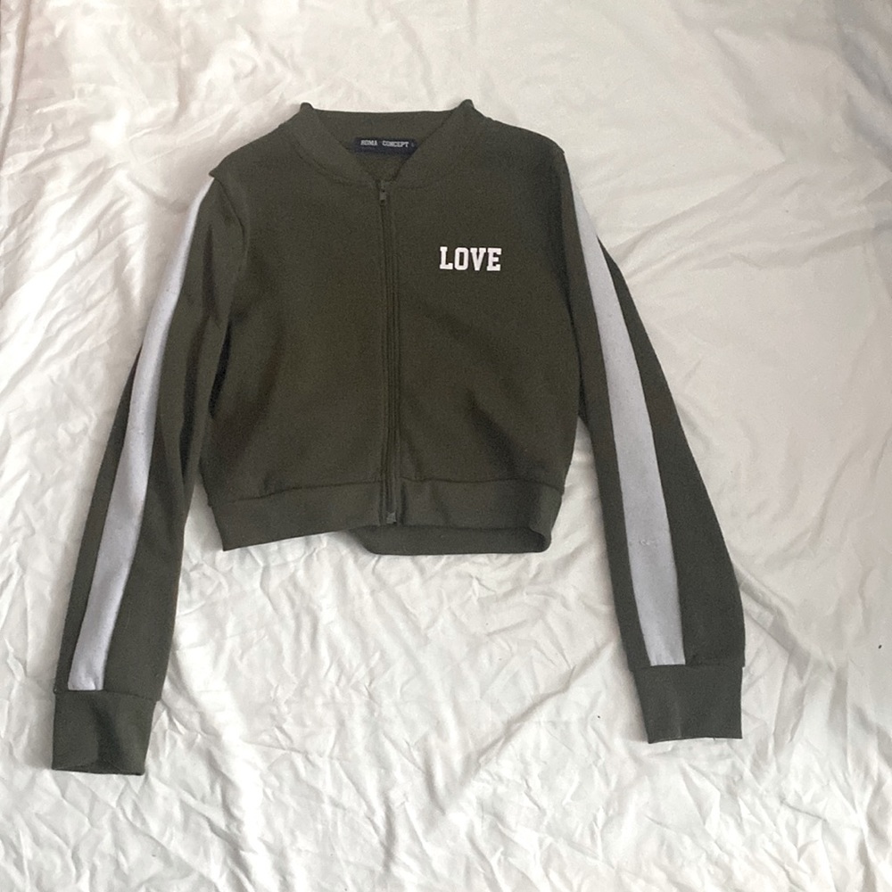 Army green with white stripped sleeves. Cropped zip up jacket. Good condition.